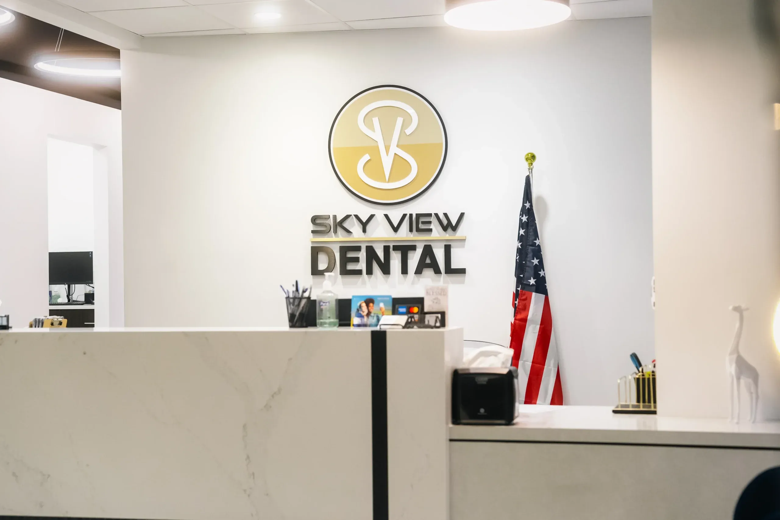 The Skyview Dental reception desk and logo wall in Noblesville