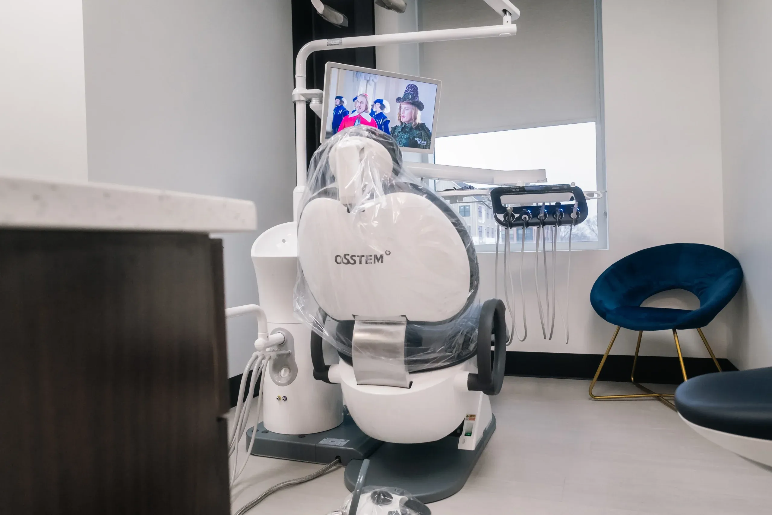 A treatment room at Skyview Dental with a ceiling-mounted screen