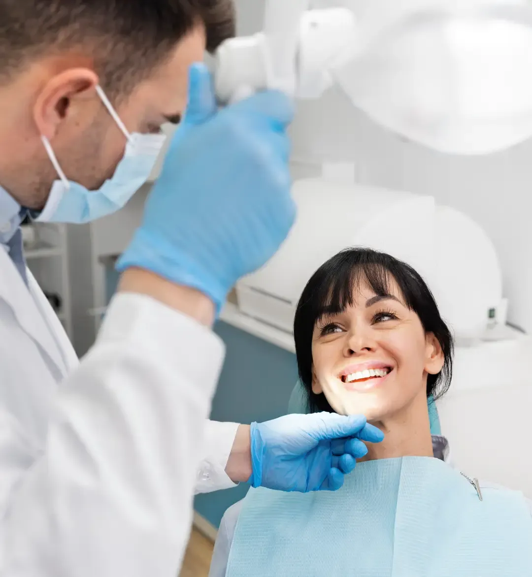 Dentist treating a smiling patient