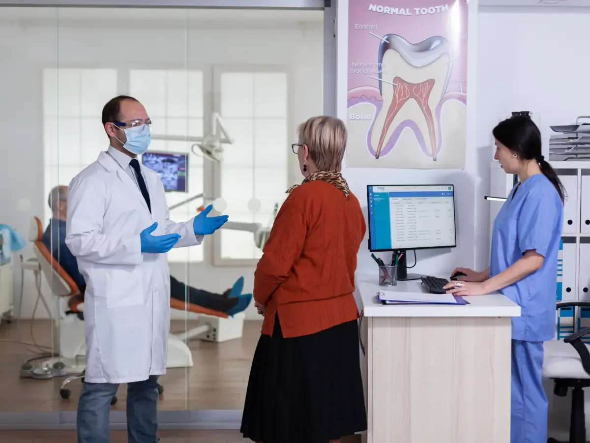 Skyview Dental in Noblesville: Dentist discussing Medicaid dental plans with patient and staff.
